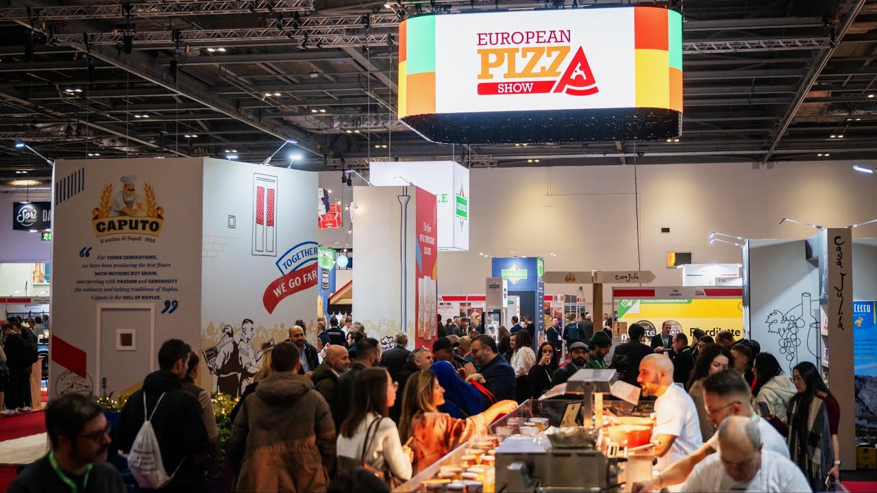 A group of people in a large exhibition hall.